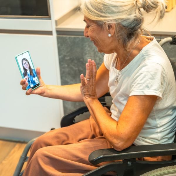 woman in a wheelchair doing a telemedicine appointment on her phone