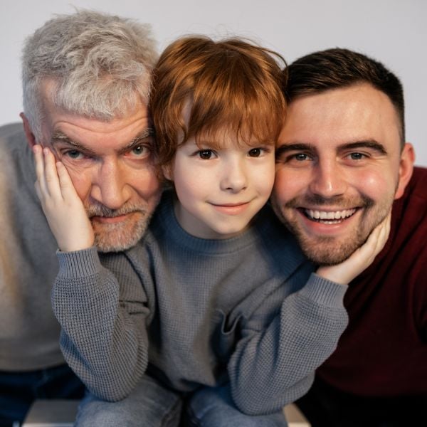 grandfather, son, and grandson all smiling