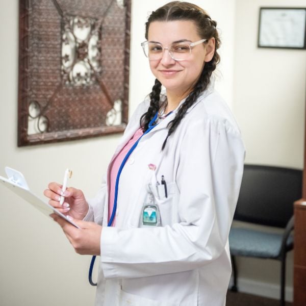 hearing specialist holding a chart and smiling