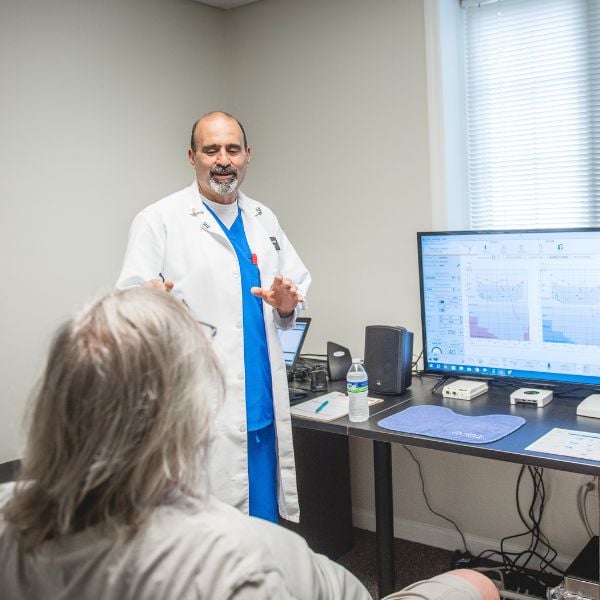 hearing specialist explaining audiogram to patient