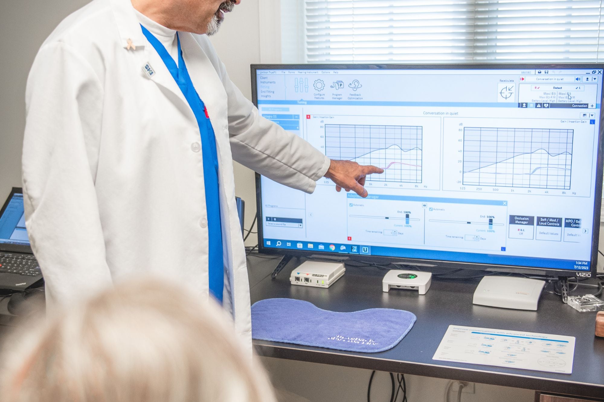 specialist showing audiogram results to patient