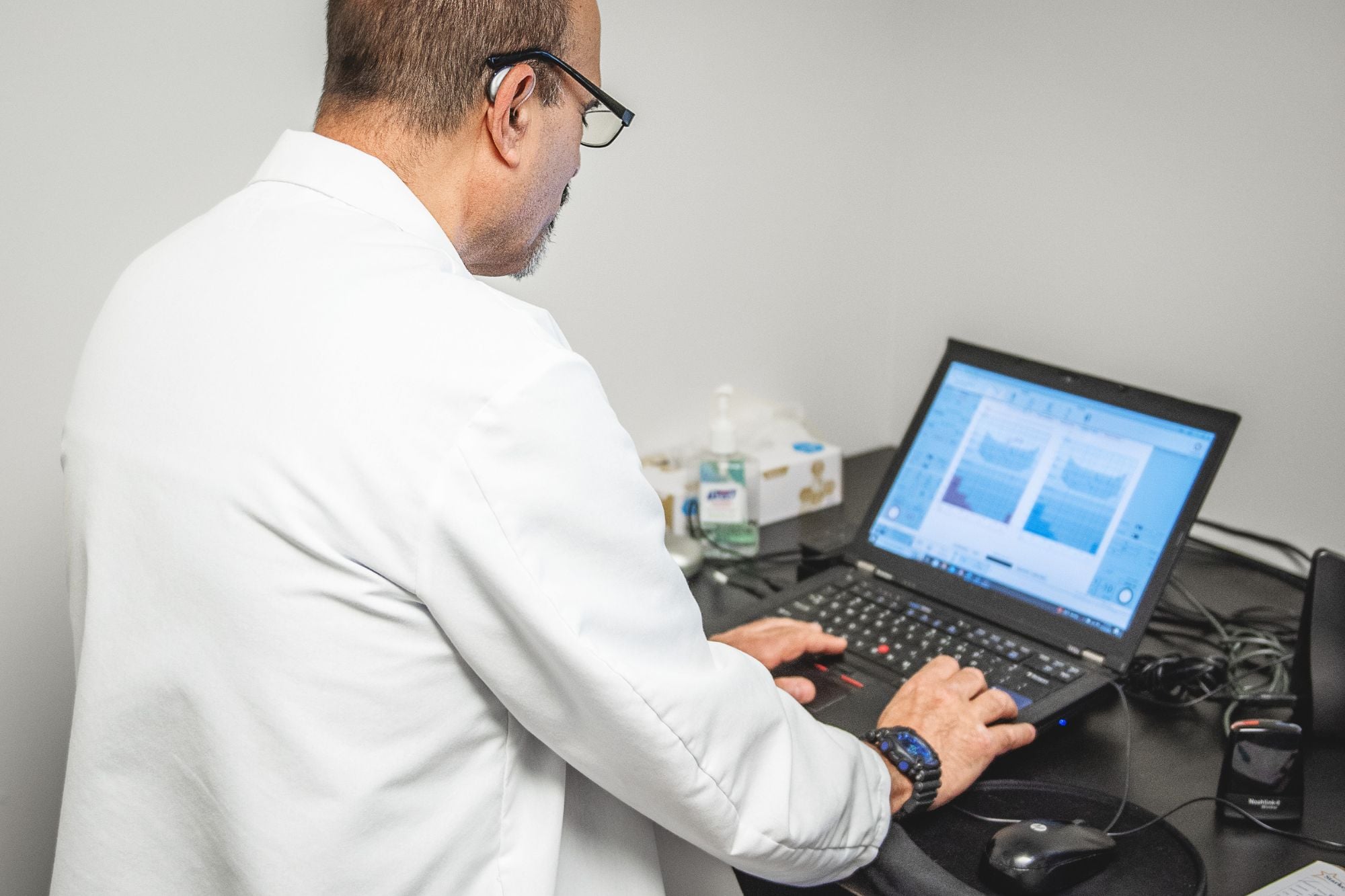 hearing specialist working on a laptop